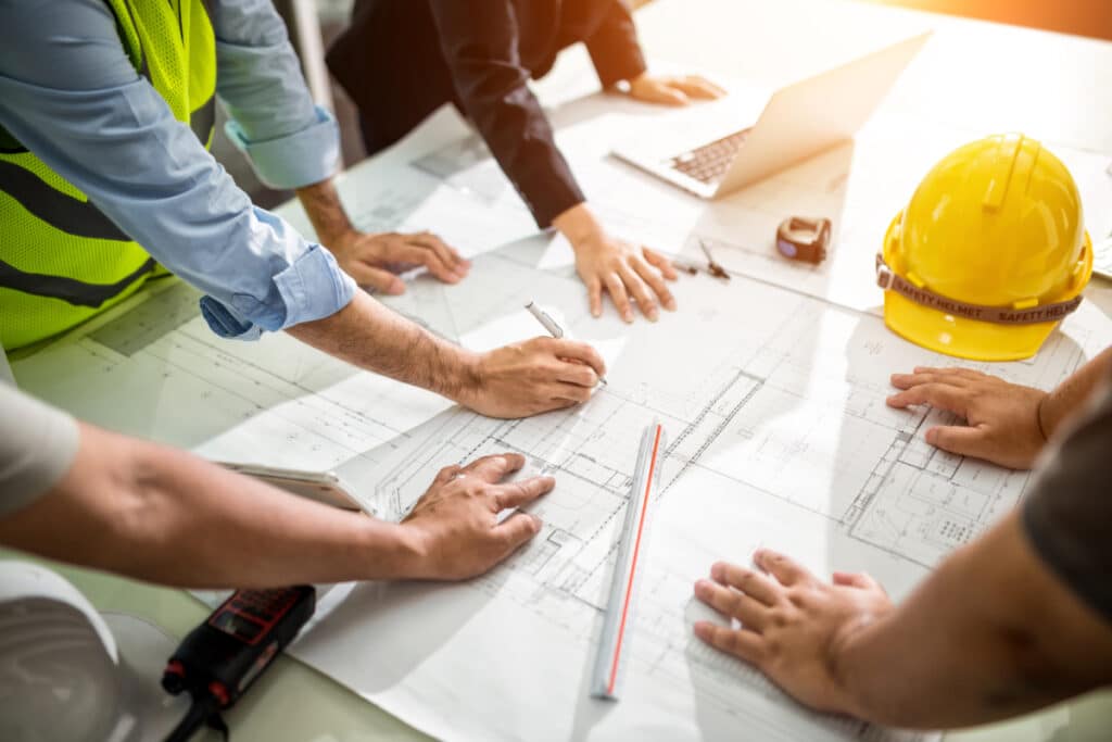 Real estate developers and construction team reviewing plans.